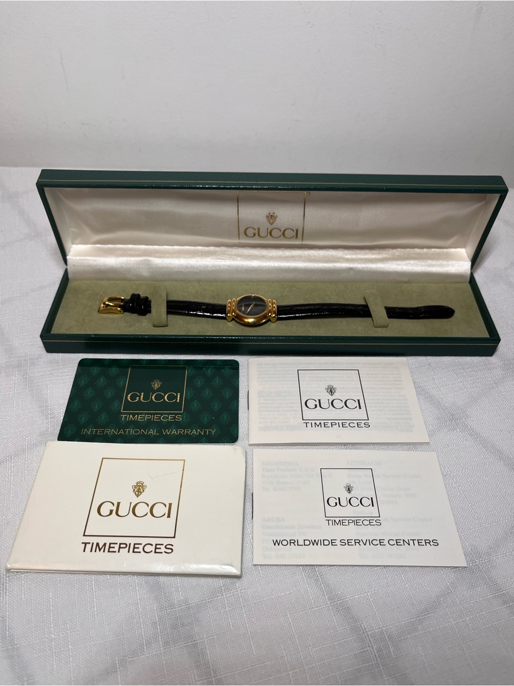 Vintage Gucci watch
striking black dial
gold-plated case
Leather strap